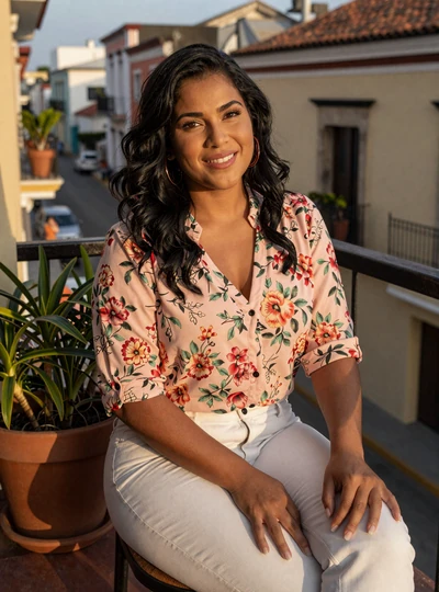 Rosa, 34, Dominican Latidreams member on a Santo Domingo balcony at golden hour